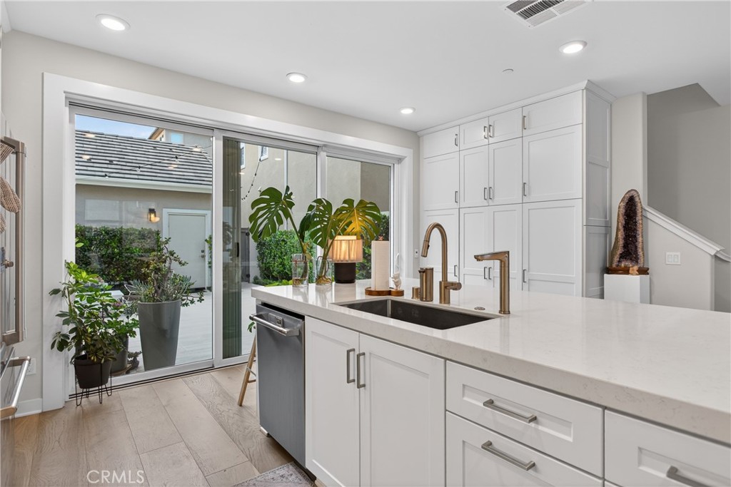 382 Chorus Irvine, CA 92618 - Photo 10 of 38 a kitchen with white cabinets and a window