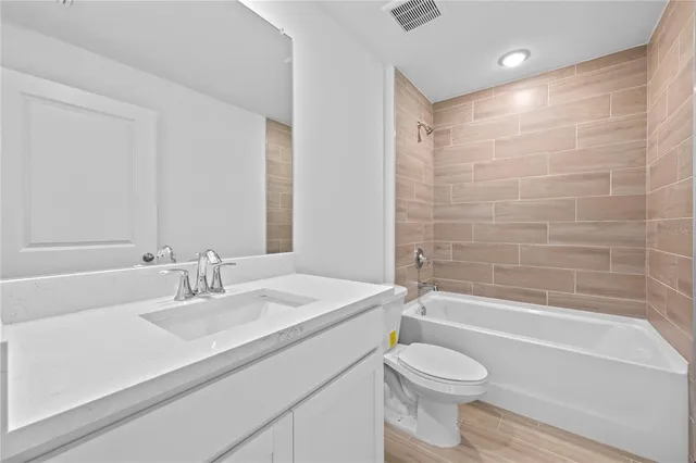 a bathroom with a sink toilet vanity and bathtub