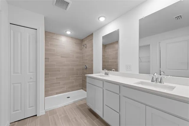 a bathroom with a double vanity sink and mirror