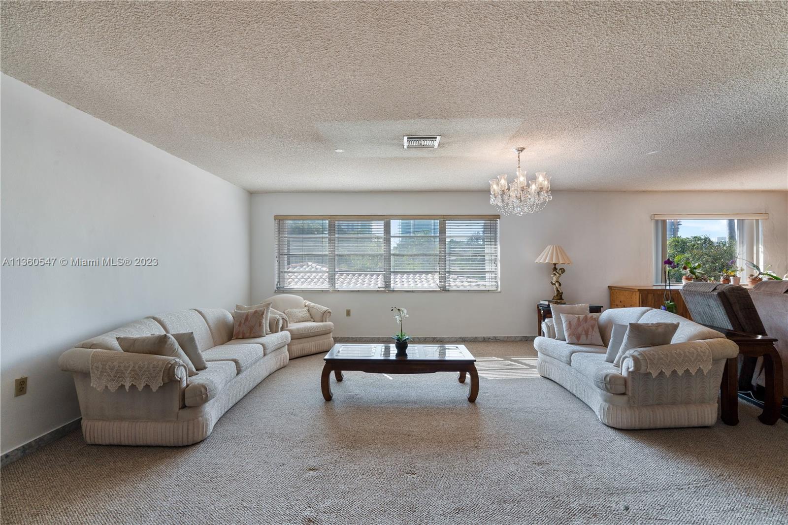 30 Southwest 21st Road Miami, FL 33129 - Photo 12 of 30 a living room with furniture and a chandelier