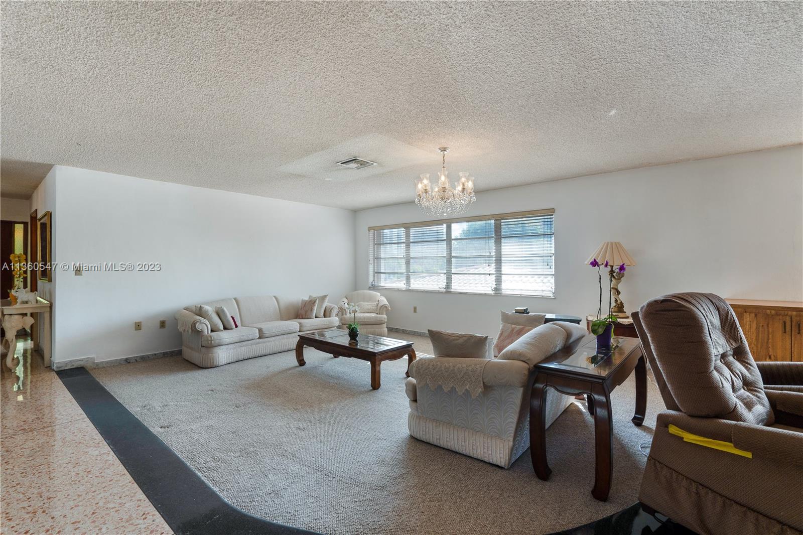 30 Southwest 21st Road Miami, FL 33129 - Photo 13 of 30 a living room with furniture and a chandelier