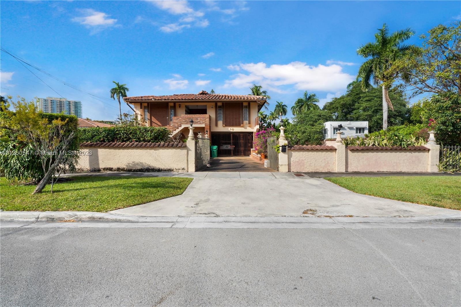 30 Southwest 21st Road Miami, FL 33129 - Photo 3 of 30 a front view of a house with a yard and a garage