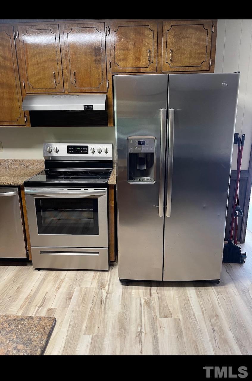 9004 Litchford Road Raleigh, NC 27615 - Photo 2 of 4 a kitchen with a refrigerator and a stove