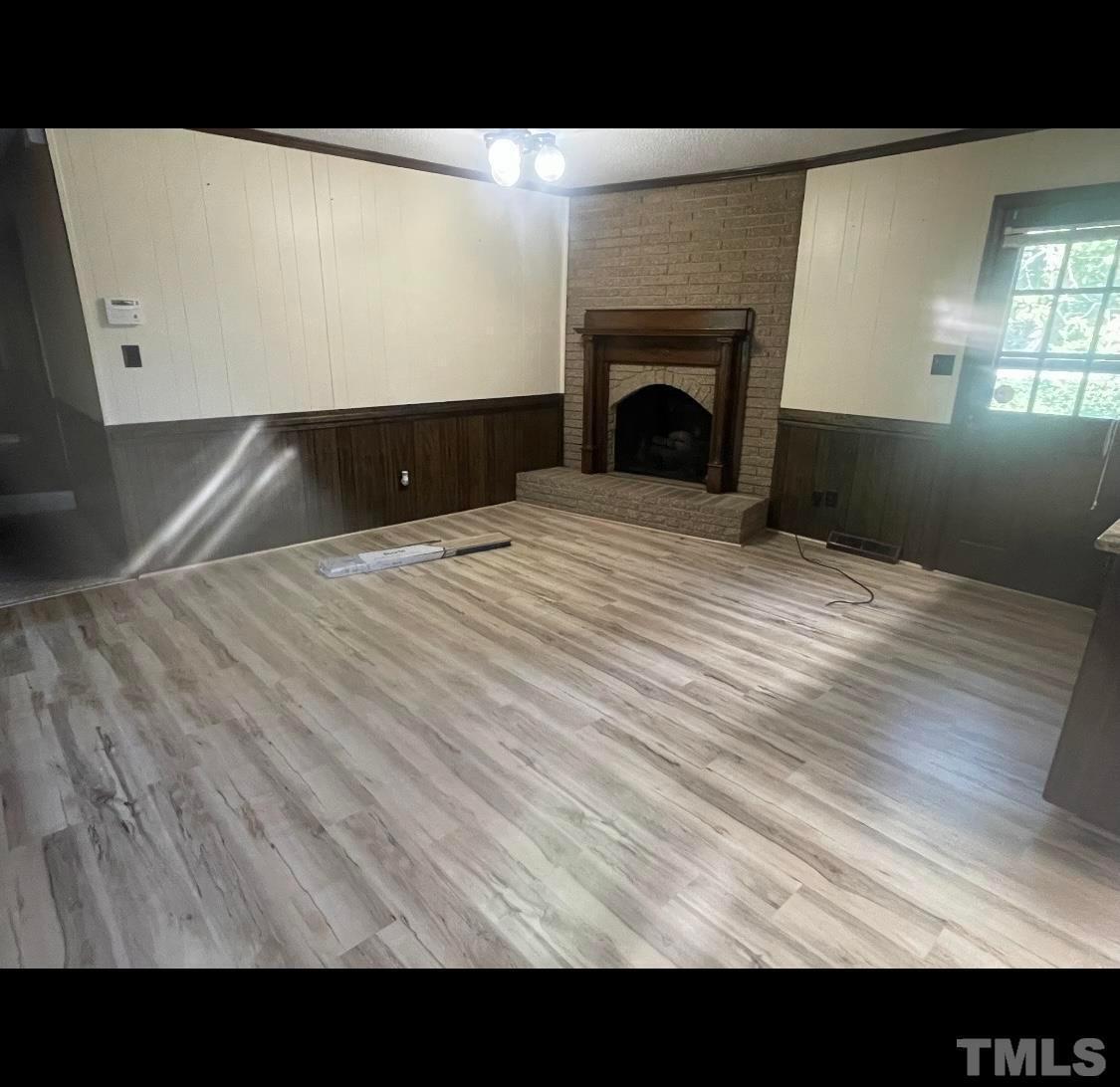 9004 Litchford Road Raleigh, NC 27615 - Photo 3 of 4 a view of empty room with wooden floor