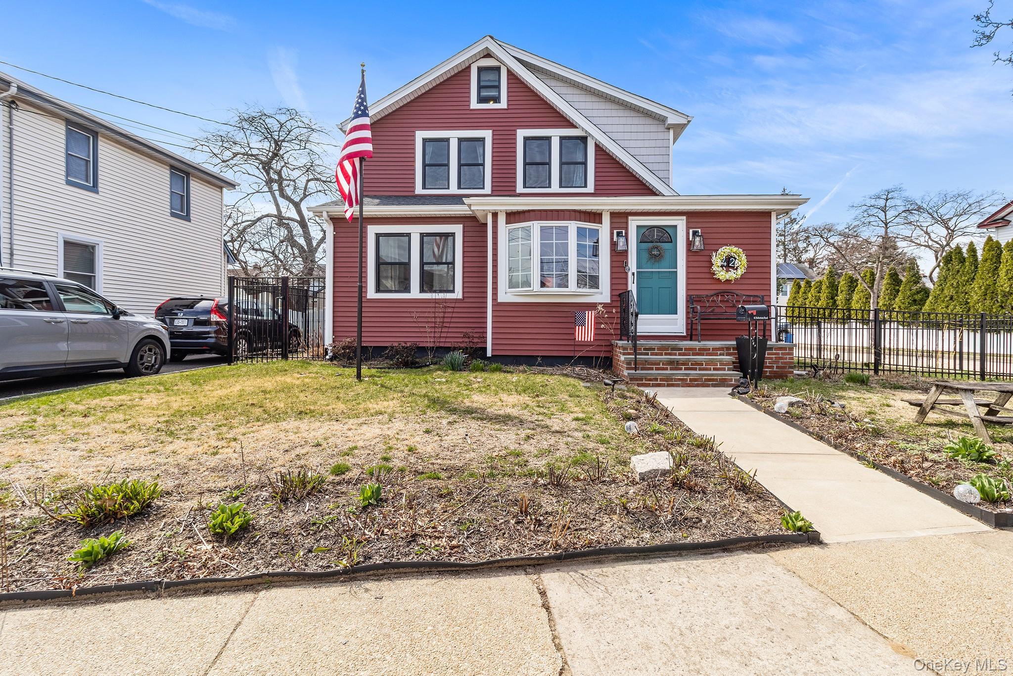 42 Robertson Road Lynbrook, NY 11563 - Photo 1 of 23 a front view of a house with a yard and garage