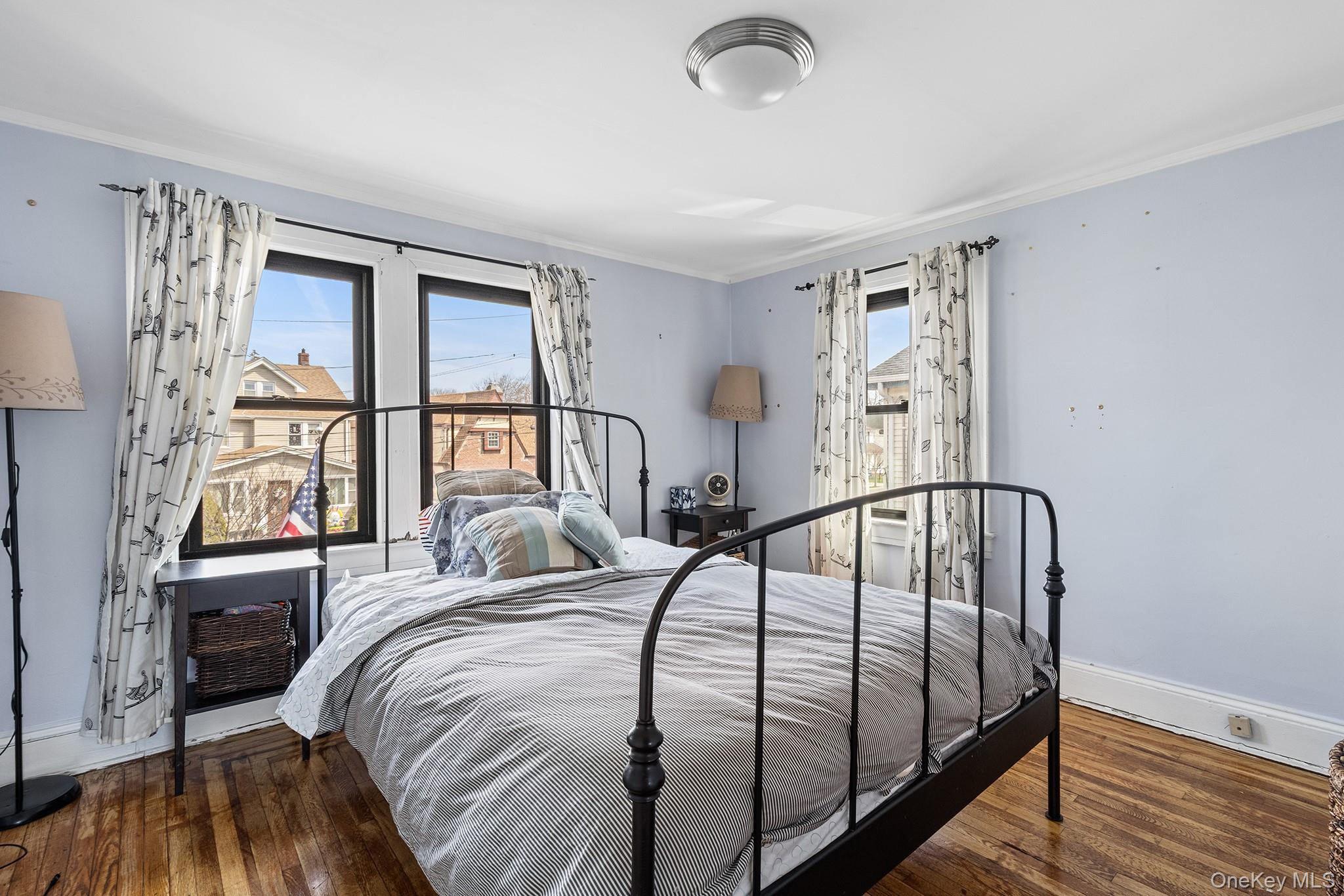 42 Robertson Road Lynbrook, NY 11563 - Photo 14 of 23 a bedroom with a bed and a large window