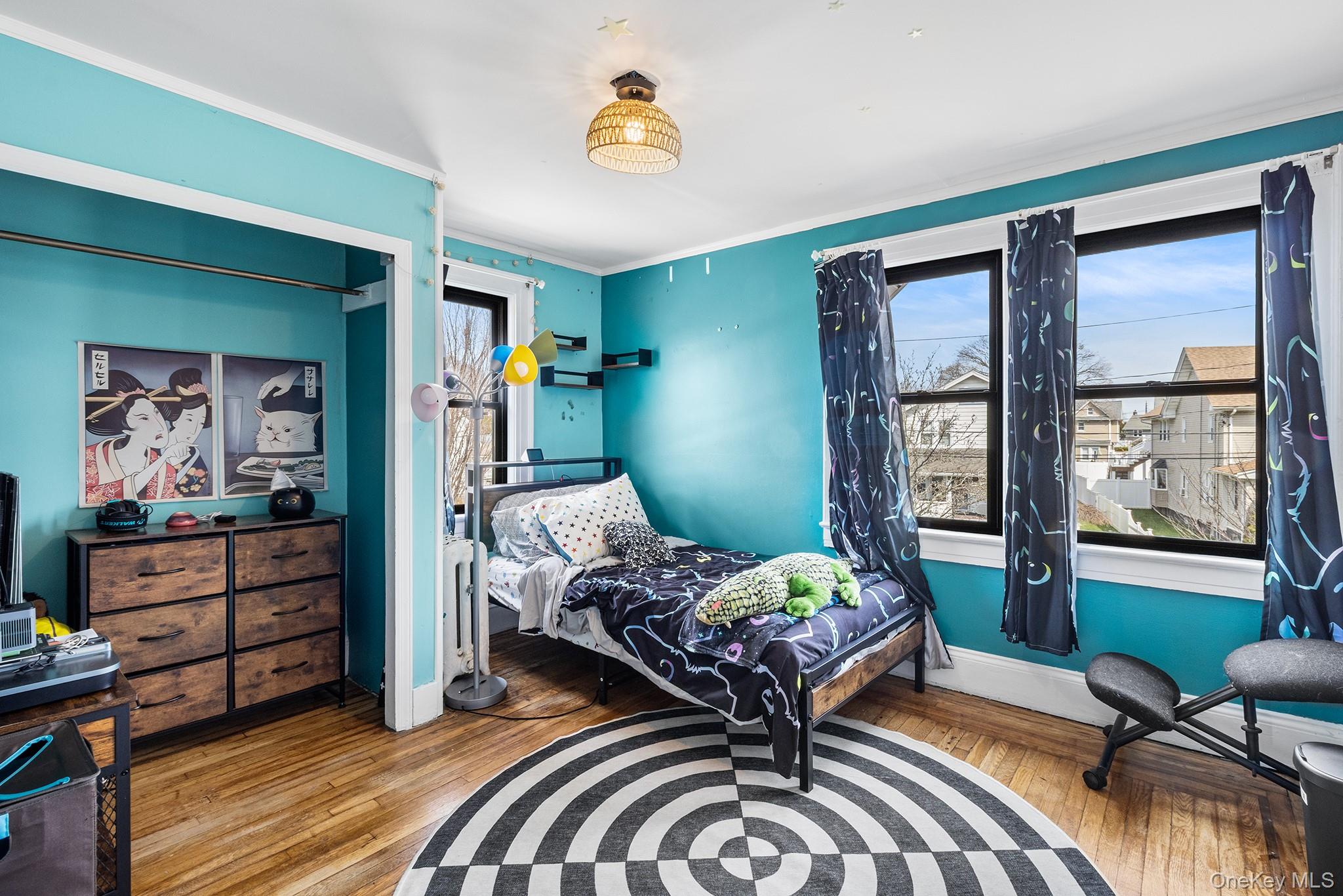 42 Robertson Road Lynbrook, NY 11563 - Photo 15 of 23 a bedroom with a bed and wooden floor