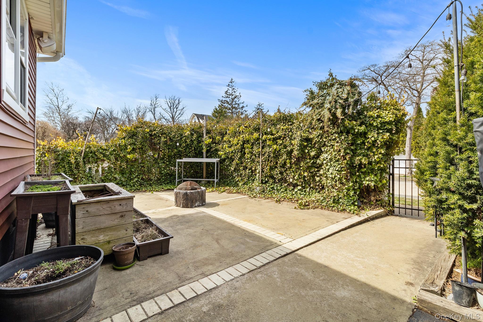 42 Robertson Road Lynbrook, NY 11563 - Photo 20 of 23 a view of backyard with outdoor seating and plants