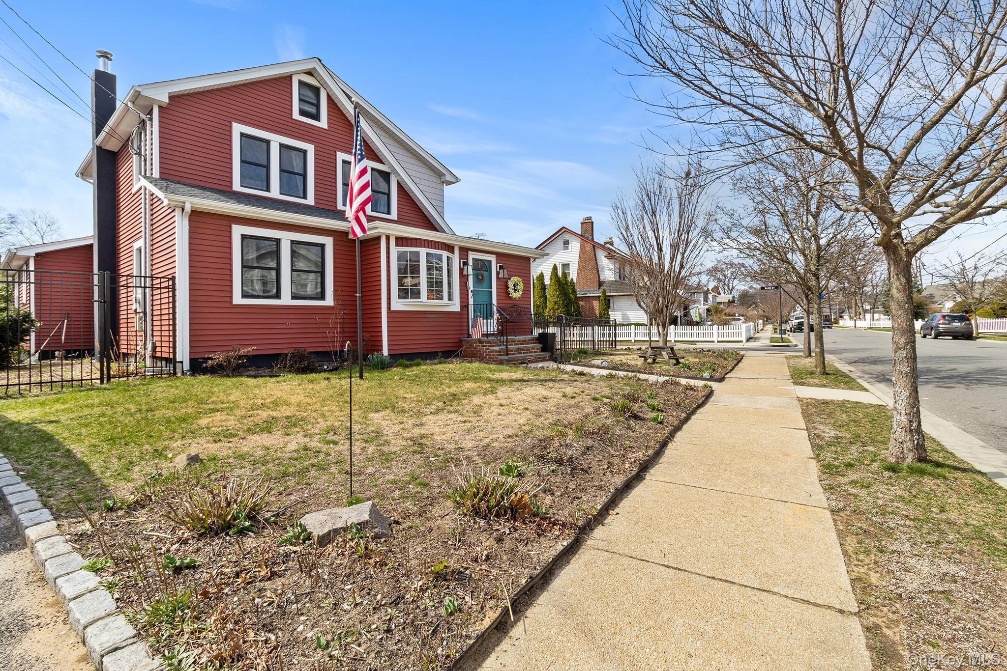 42 Robertson Road Lynbrook, NY 11563 - Photo 2 of 23 a front view of building with yard