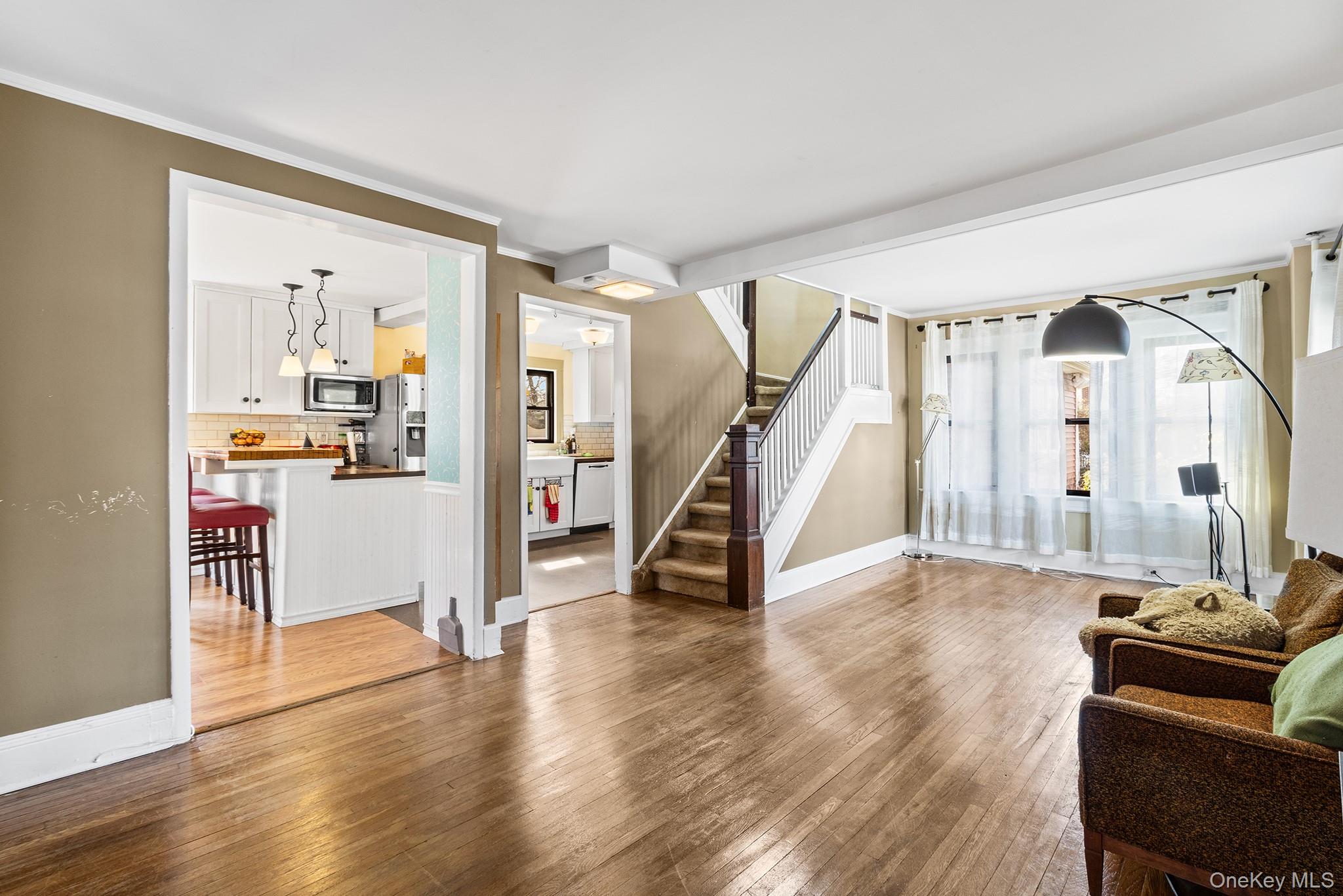 42 Robertson Road Lynbrook, NY 11563 - Photo 5 of 23 a view of a livingroom with wooden floor and furniture