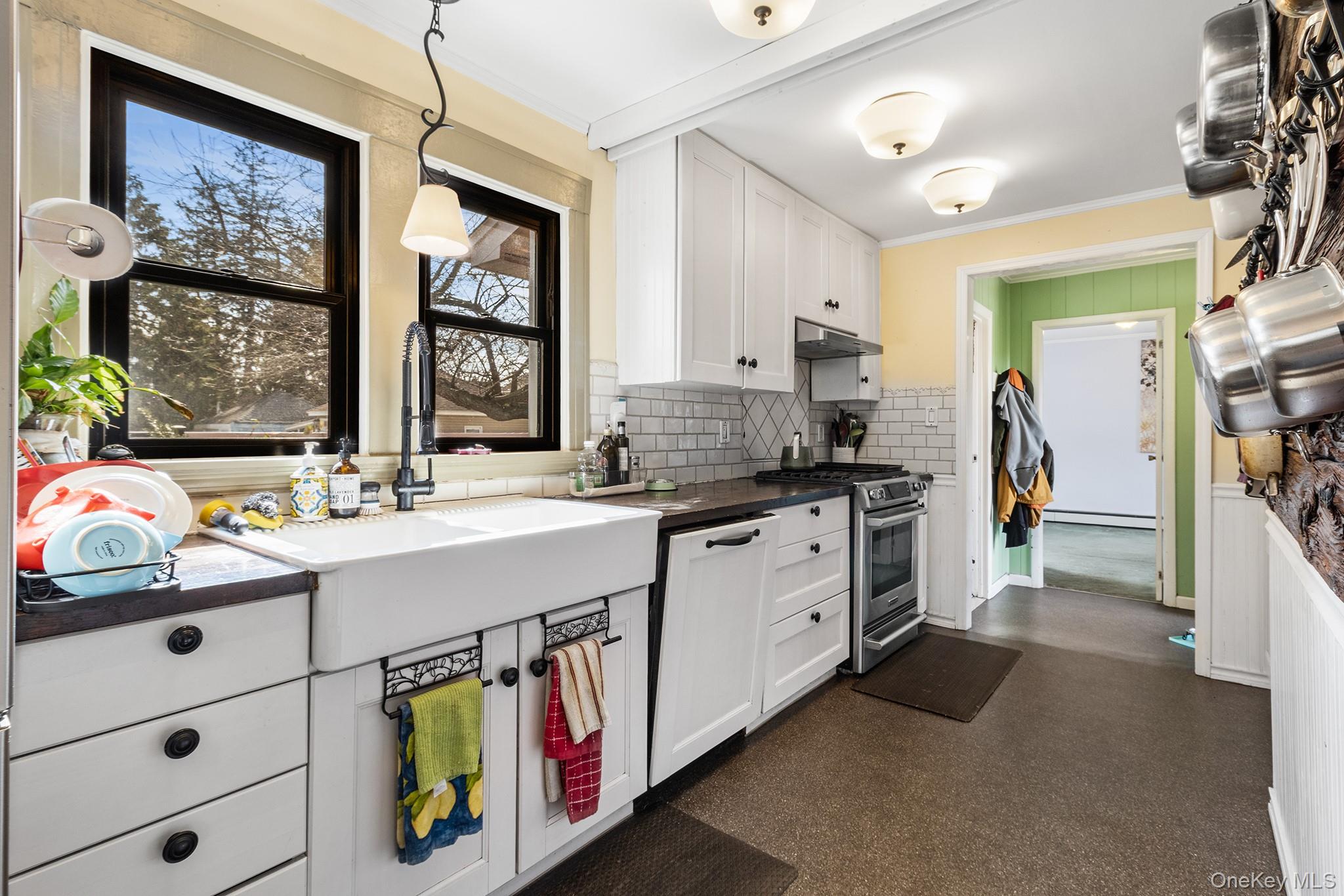 42 Robertson Road Lynbrook, NY 11563 - Photo 8 of 23 a kitchen that has a lot of cabinets in it and wooden floors