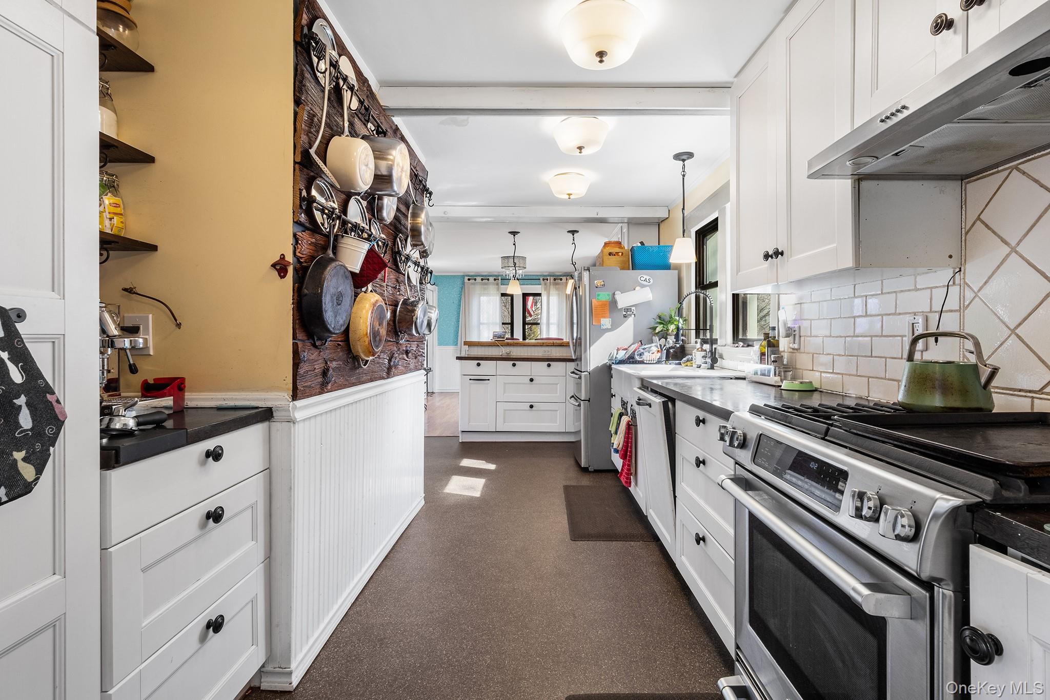 42 Robertson Road Lynbrook, NY 11563 - Photo 9 of 23 a kitchen with stainless steel appliances and white cabinets
