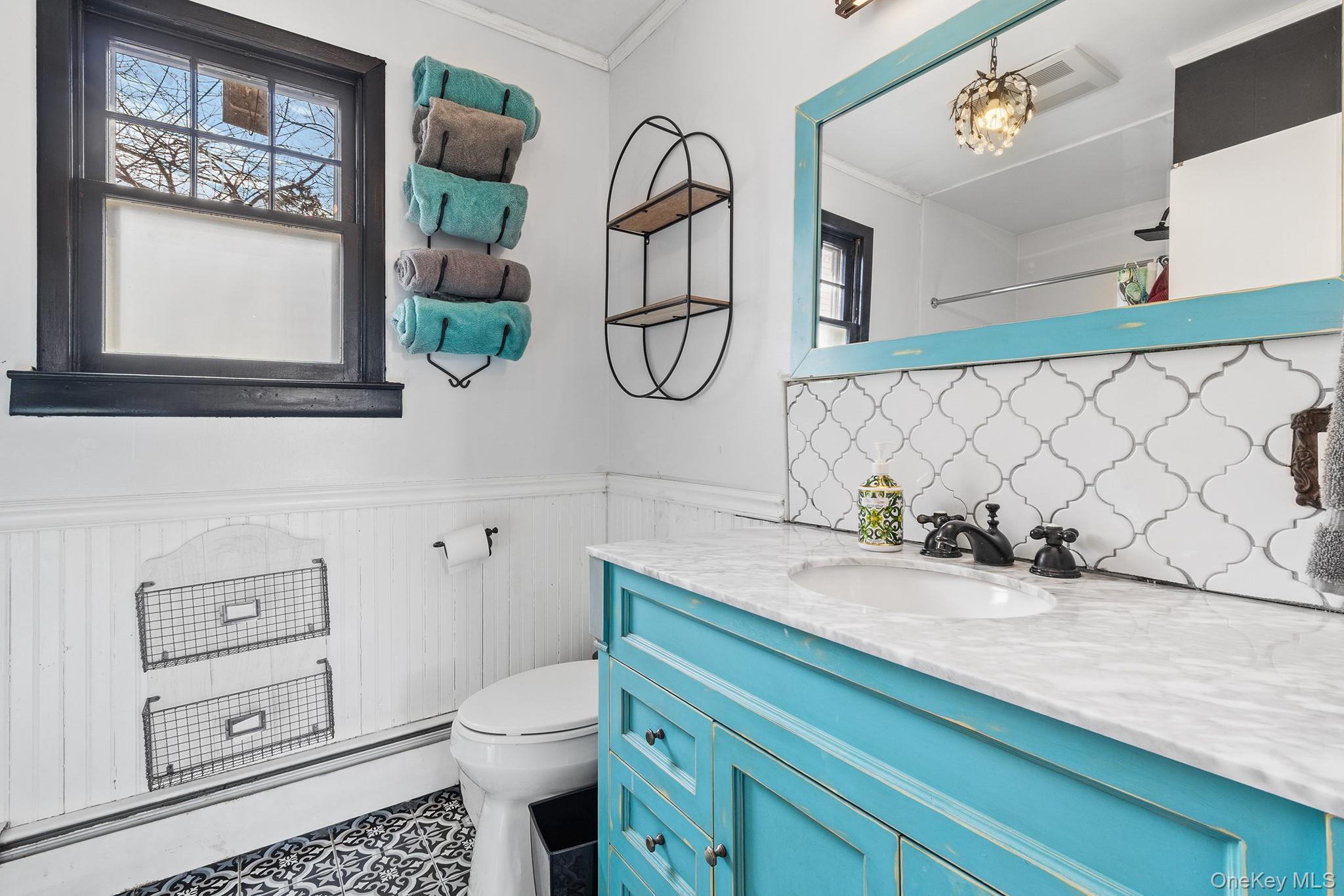 42 Robertson Road Lynbrook, NY 11563 - Photo 10 of 23 a bathroom with a granite countertop toilet sink and mirror