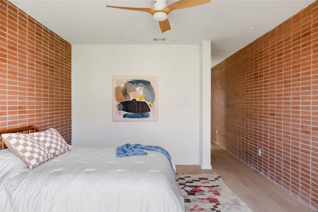 a bedroom with a bed and a painting on the wall