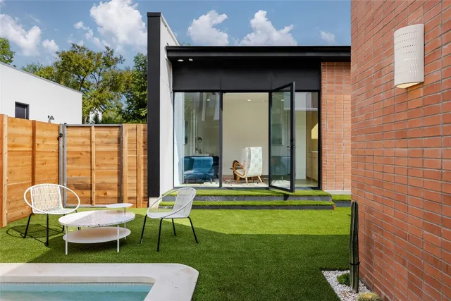 a front view of a house with outdoor seating