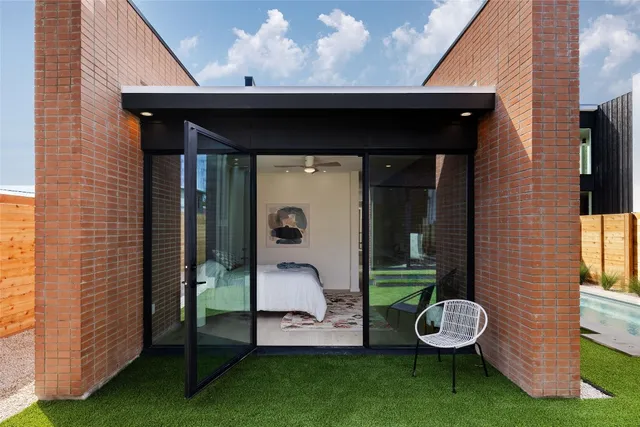 a front view of a house with garden and patio