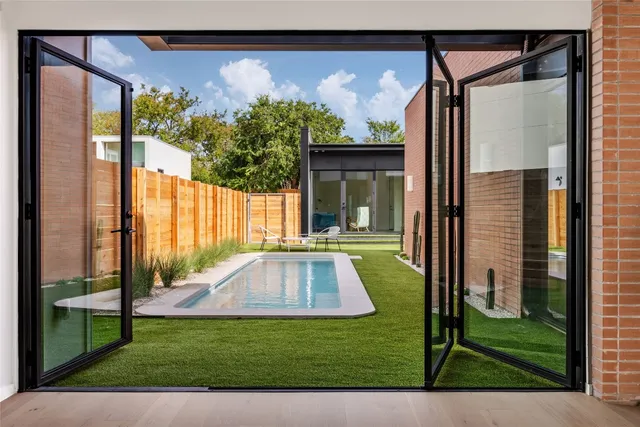 a view of a porch with a floor to ceiling window and a yard