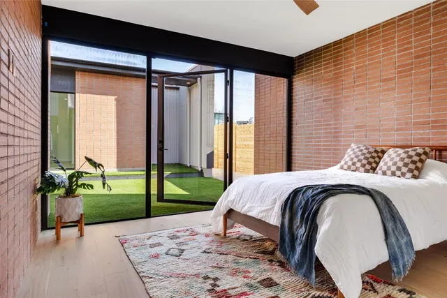 a bed sitting in a bedroom next to a window