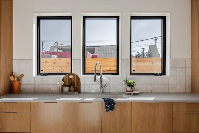 a bathroom with sinks and a large mirror next to a window