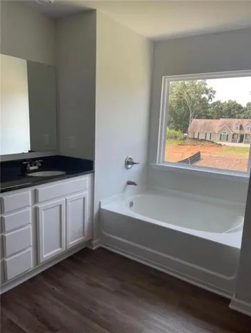 a bathroom with a bathtub and a window
