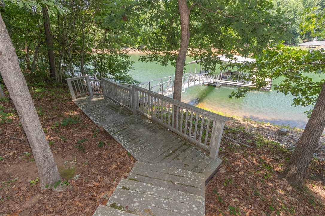 202 Plantation Point Anderson, SC 29625 - Photo 44 of 48 Concrete steps descend to a private boat dock and serene waterfront access.