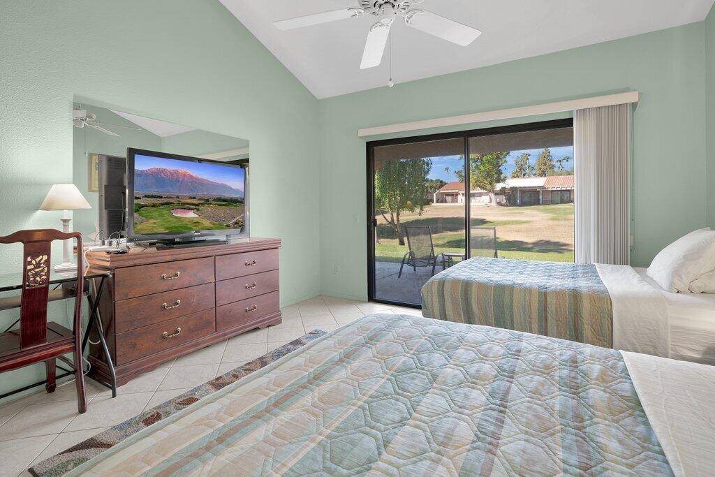 41071 Preston Trail Palm Desert, CA 92211 - Photo 13 of 29 a bedroom with a bed and a flat tv screen on dresser