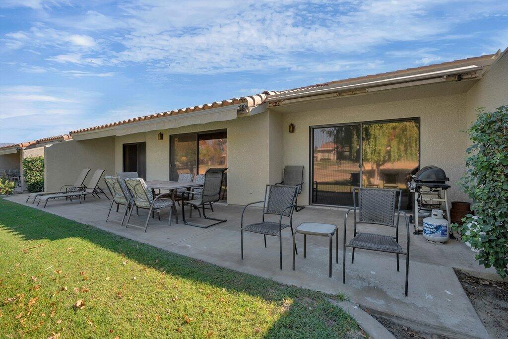 41071 Preston Trail Palm Desert, CA 92211 - Photo 15 of 29 a view of a patio with table and chairs potted plants and a large tree