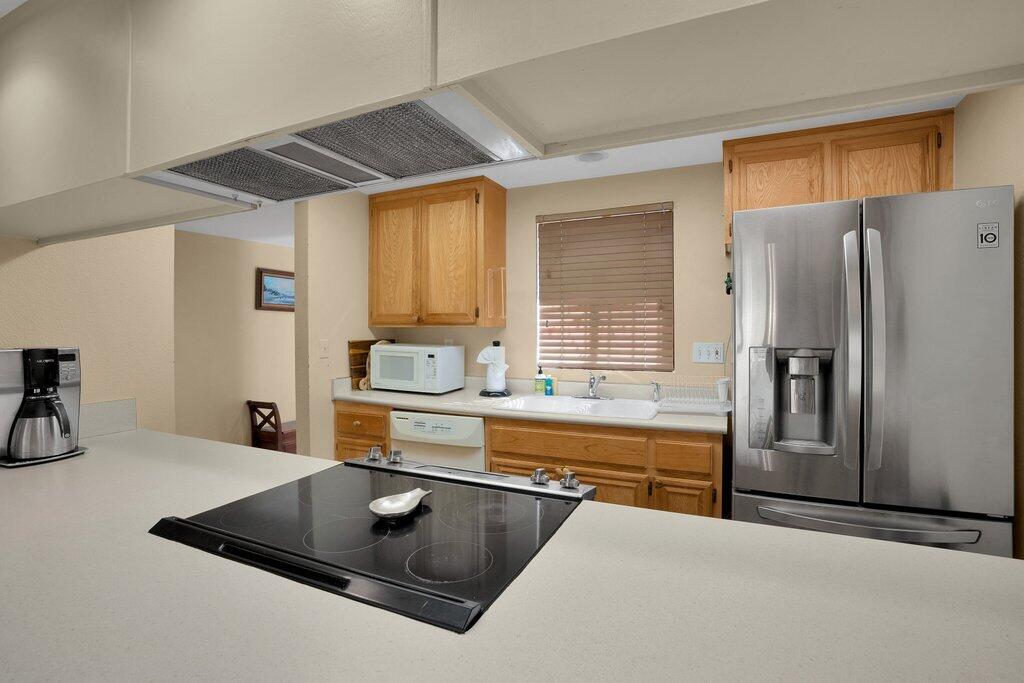 41071 Preston Trail Palm Desert, CA 92211 - Photo 2 of 29 a kitchen with stainless steel appliances granite countertop a refrigerator a sink a stove and a refrigerator with wooden cabinets