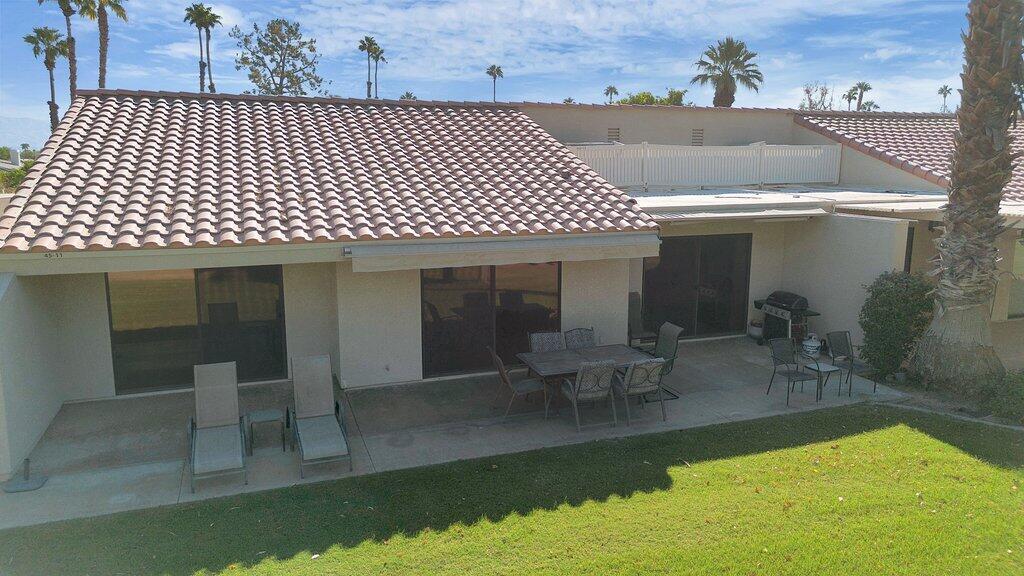 41071 Preston Trail Palm Desert, CA 92211 - Photo 21 of 29 a view of a patio with table and chairs with wooden floor and fence