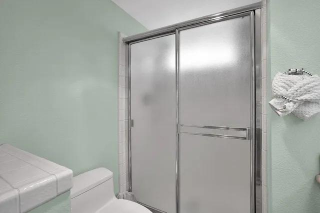 a bathroom with a glass shower door