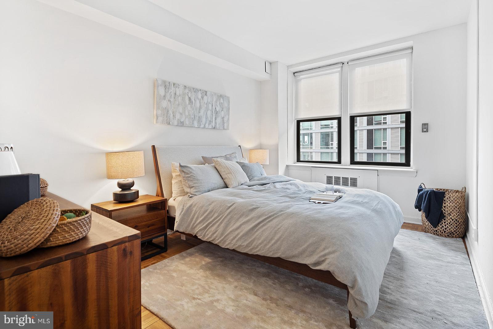 2201 Pennsylvania Avenue, Unit 908 Philadelphia, PA 19130 - Photo 14 of 45 a bedroom with a bed and wooden floor