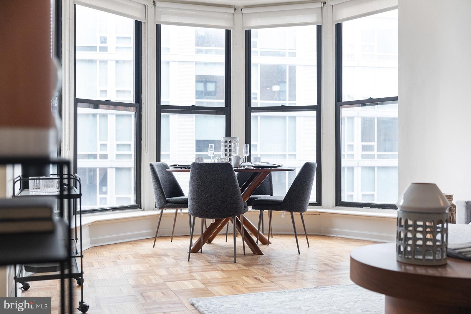 2201 Pennsylvania Avenue, Unit 908 Philadelphia, PA 19130 - Photo 3 of 45 a dining room with furniture a rug and a large window