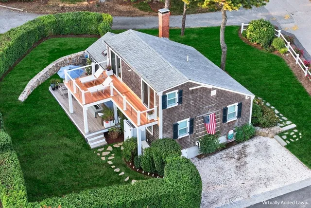a aerial view of a house with a yard and plants