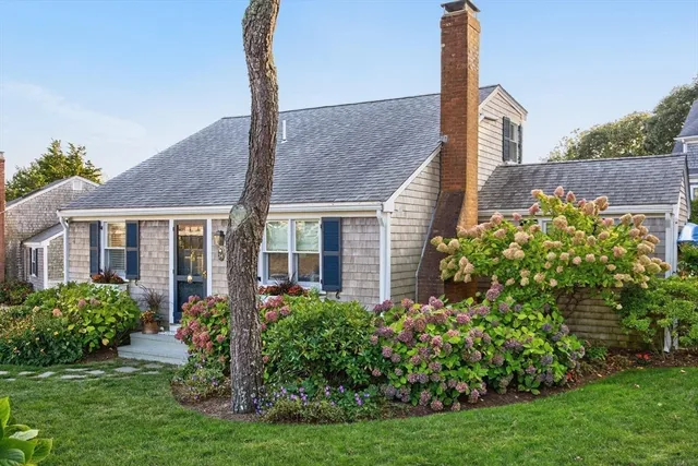 a view of a patio with table and chairs under an umbrella