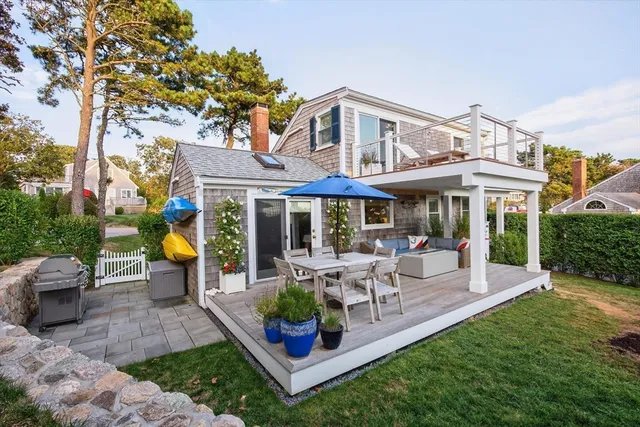 a view of a house with a yard patio and furniture