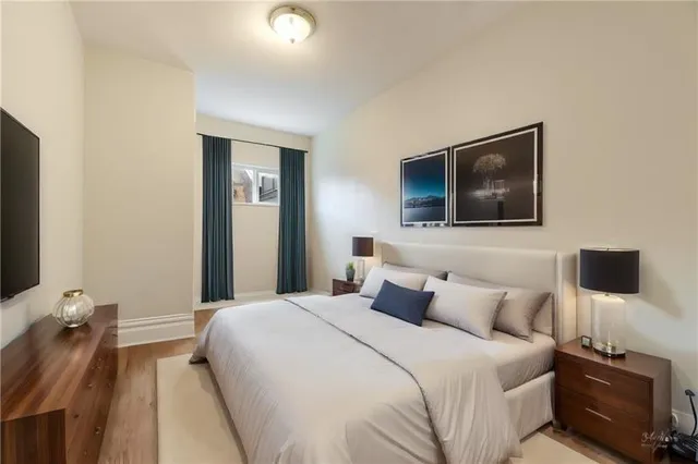 a bedroom with a bed and a flat screen tv