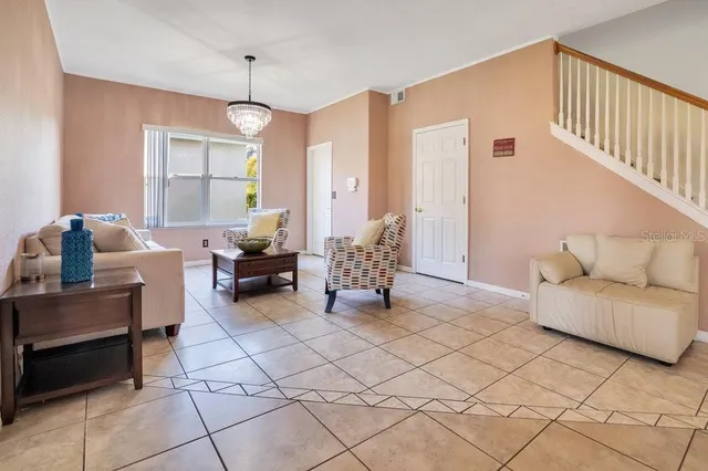 a living room with furniture and a chandelier