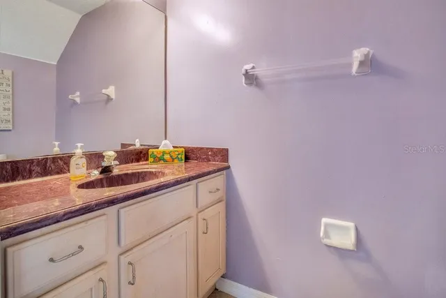 a bathroom with a sink and mirror