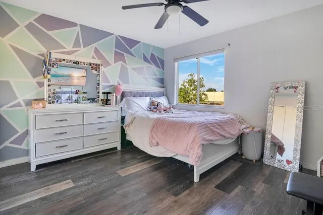 a bedroom with a bed and a dresser