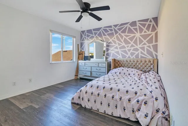 a bedroom with a bed and a dresser