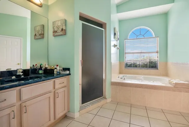 a bathroom with a sink vanity and mirror