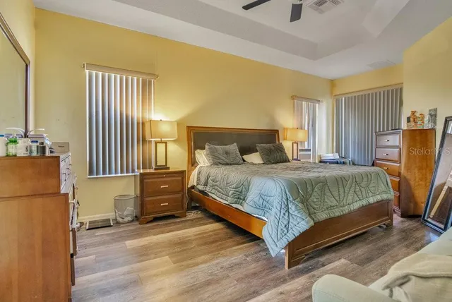 a bedroom with a bed and wooden floor