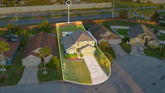 an aerial view of a house with a swimming pool