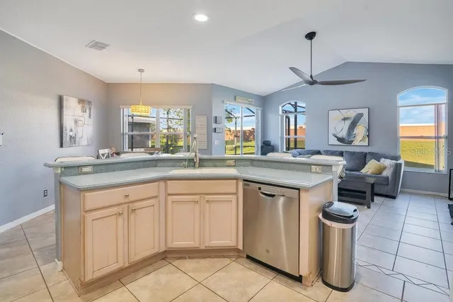 a kitchen with a sink and white cabinets