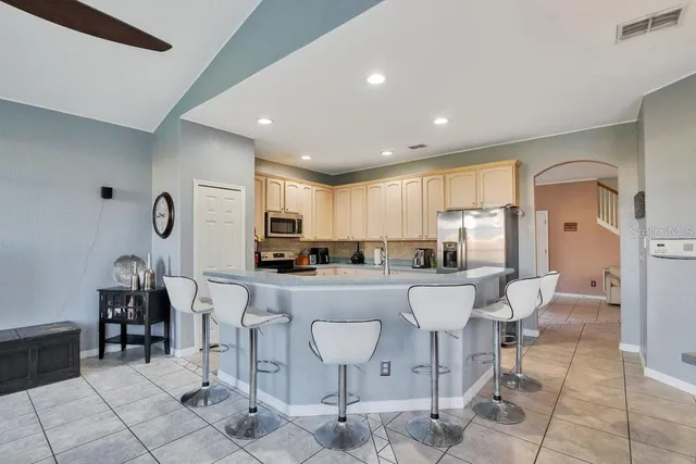 a living room with furniture a table and chairs