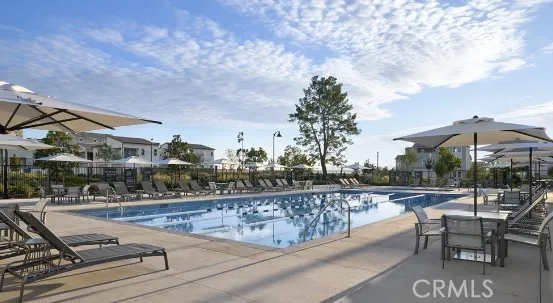 a view of a swimming pool with a patio and a yard