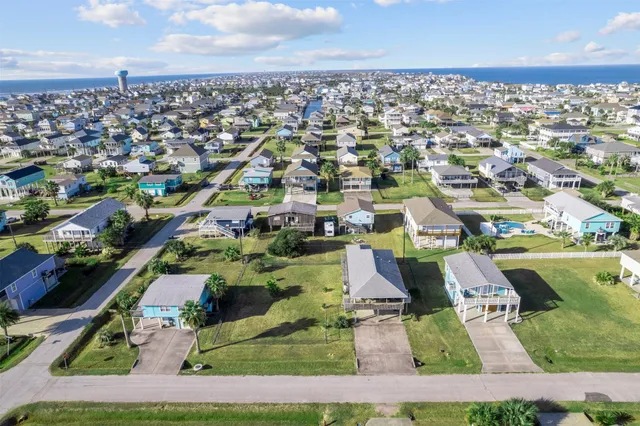 an aerial view of residential houses with outdoor space