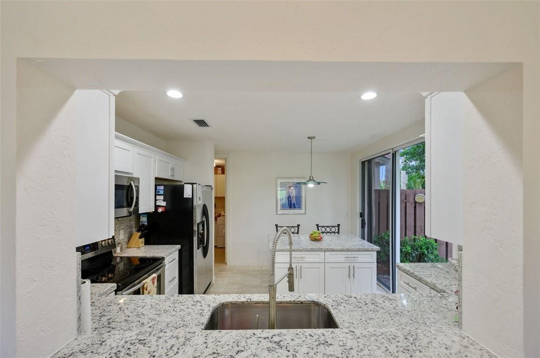 5887 Northwest 24th Avenue, Unit 1201 Boca Raton, FL 33496 - Photo 12 of 47 PASSTHROUGH INTO KITCHEN
