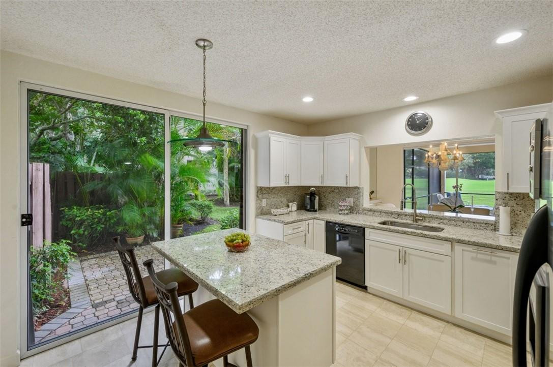 5887 Northwest 24th Avenue, Unit 1201 Boca Raton, FL 33496 - Photo 13 of 47 KITCHEN WITH PATIO