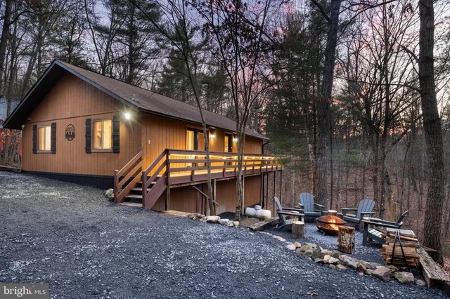 a view of a house with backyard and chairs